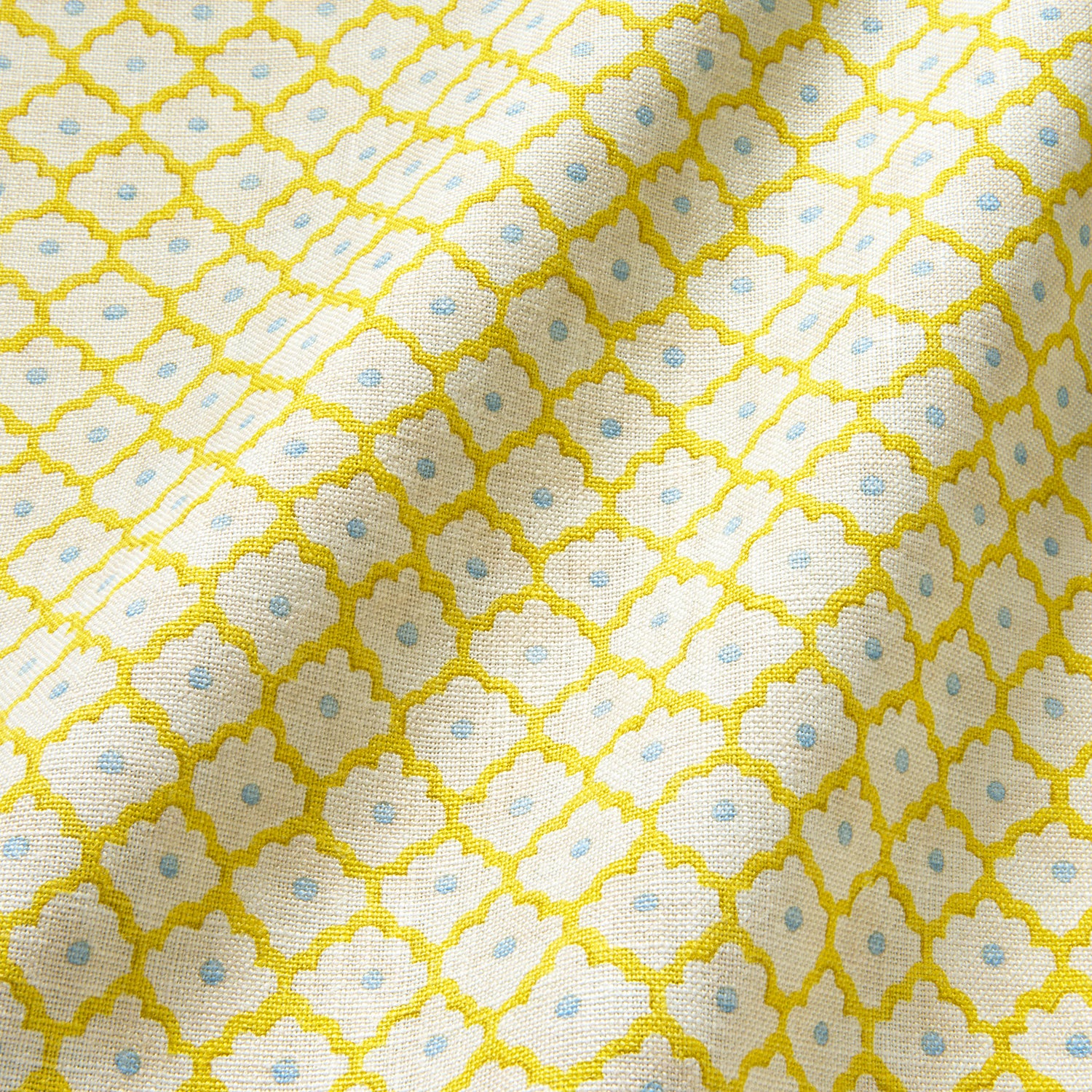 Printed linen fabric sample - a classic trellis design in blue, yellow, and cream