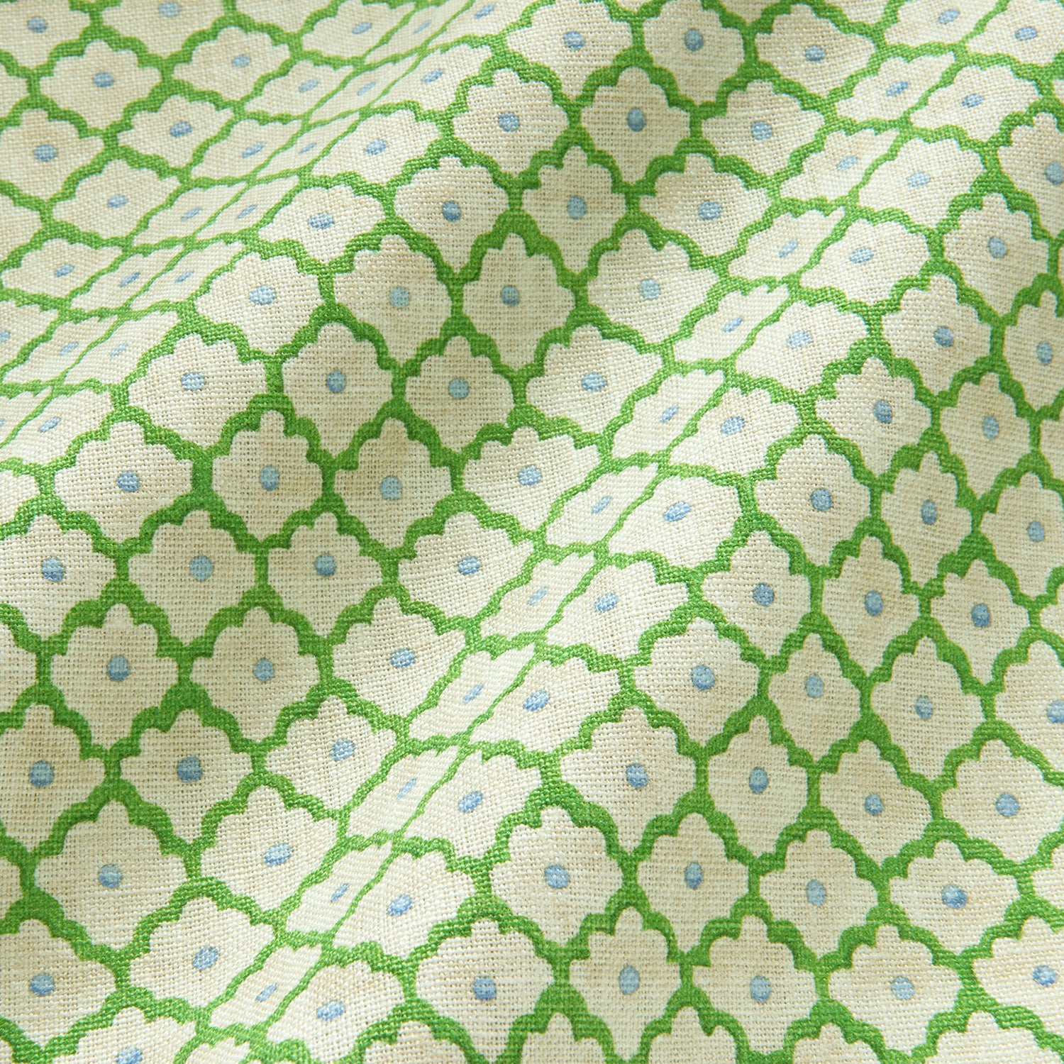 Printed linen fabric sample - a classic trellis design in blue, green, and cream