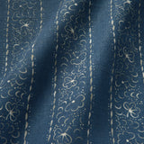 Printed linen fabric sample – a delicate pattern of moons and star-like dots in blue and cream