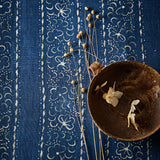 Printed linen fabric sample – a delicate pattern of moons and star-like dots in blue and cream