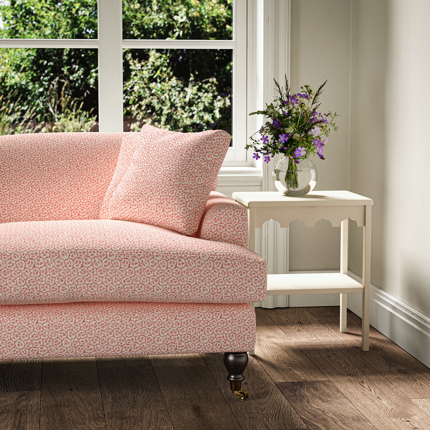 Printed linen fabric – a handy block print pattern in pink and cream – on a sofa