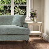 Printed linen fabric – a handy block print pattern in blue and cream – on a sofa