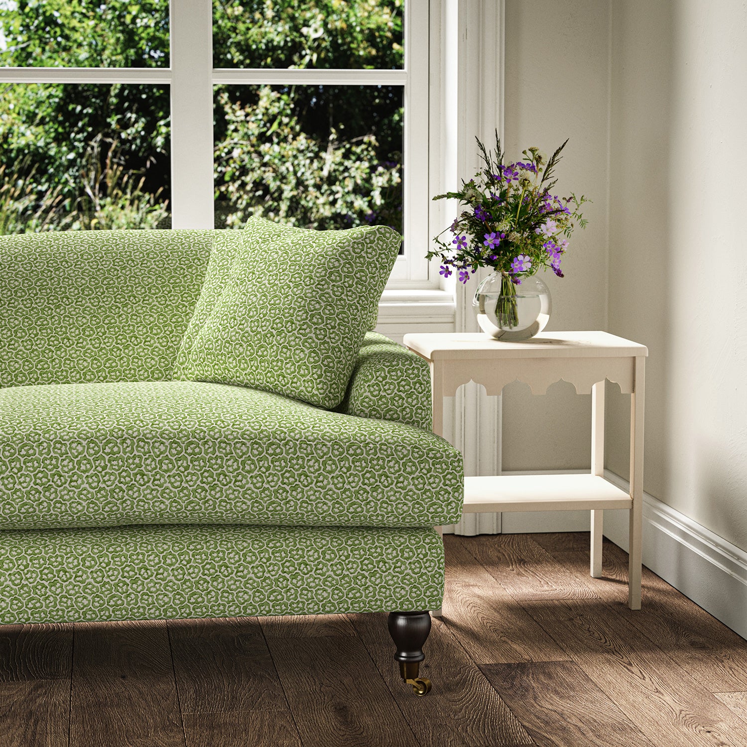 Printed linen fabric – a handy block print pattern in green and cream – on a sofa