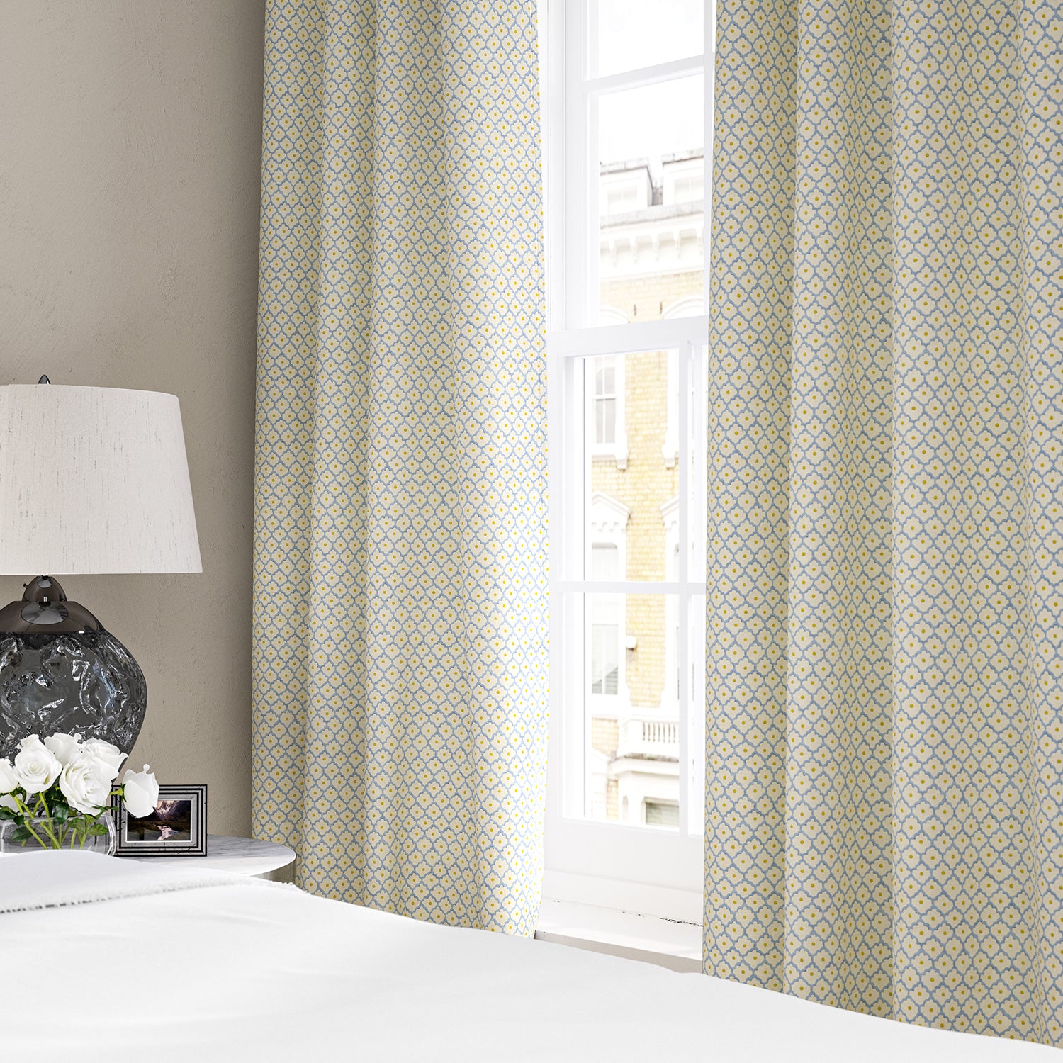 Linen curtains with a classic trellis design in blue, yellow, and cream