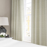 Linen curtains with a classic trellis design in blue, yellow, and cream