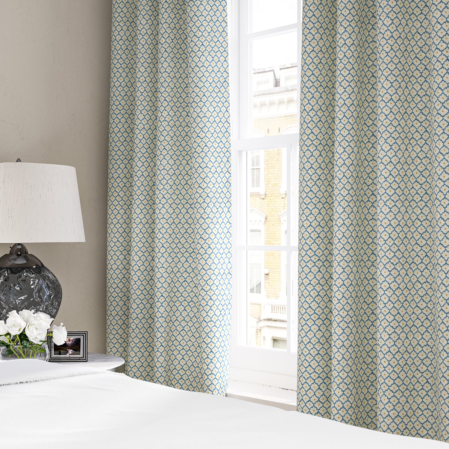Linen curtains with a classic trellis design in blue, yellow, and cream.