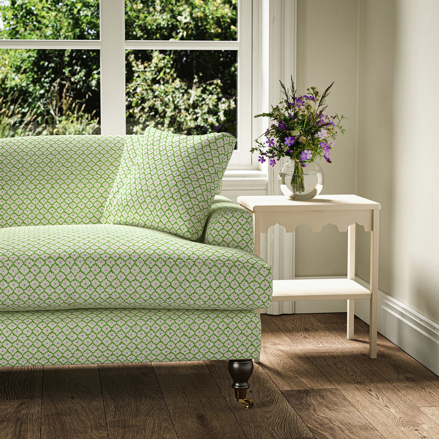 Printed linen fabric – a classic trellis design in blue, green, and cream – on a sofa