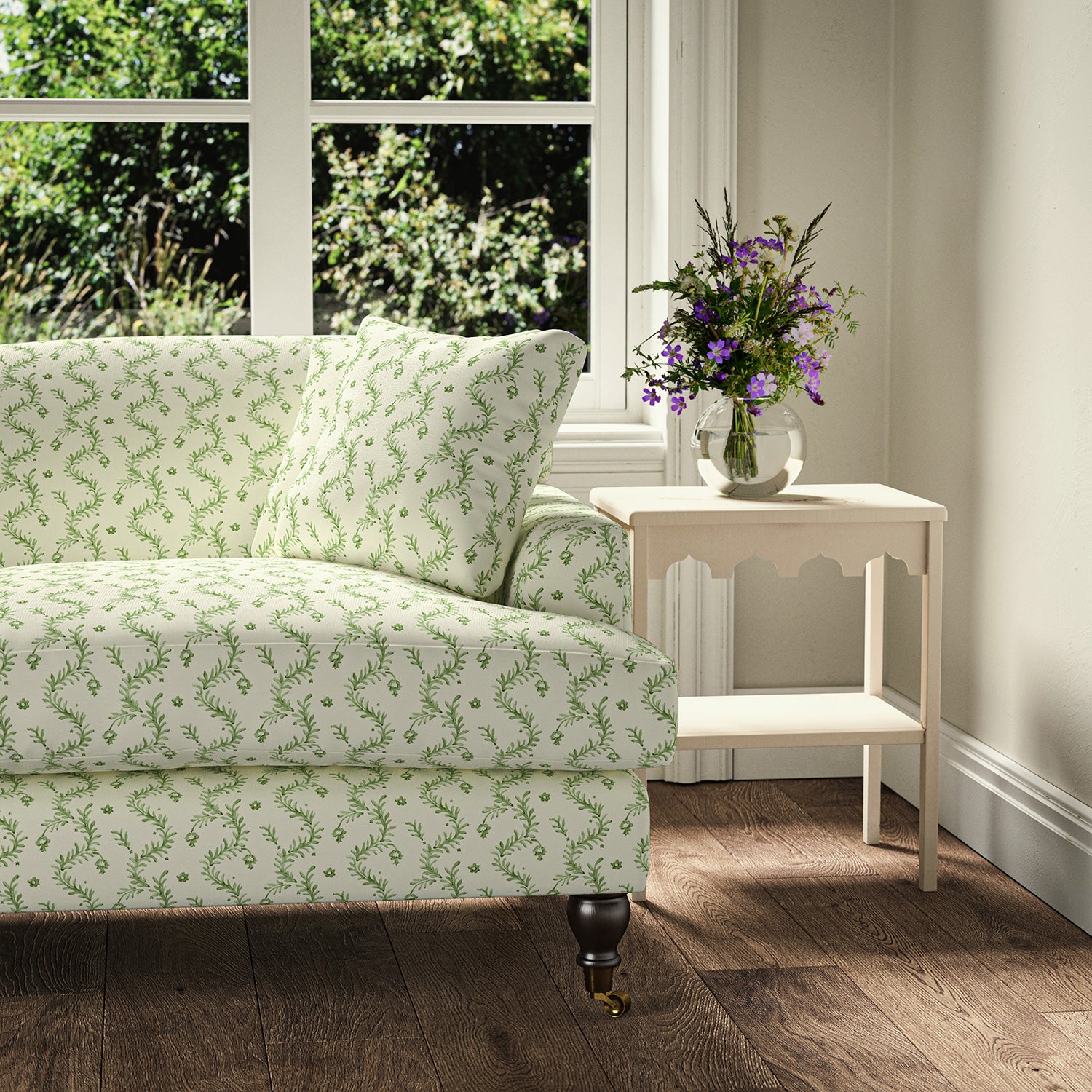 Printed linen fabric - a charming marine-style pattern in green and cream – on a sofa