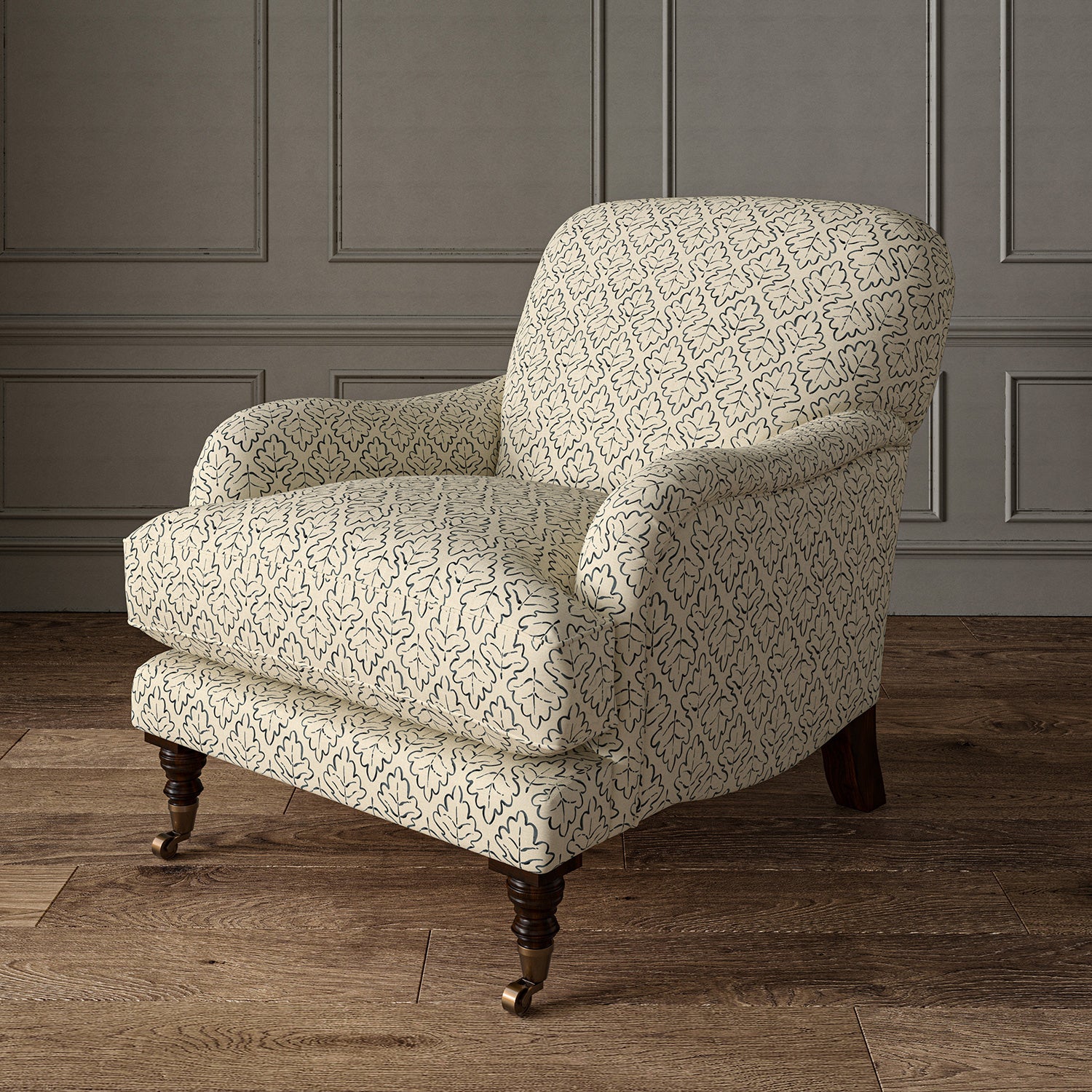 Printed linen fabric – a hand drawn; mirrored leaf motif pattern in blue and cream – on an armchair