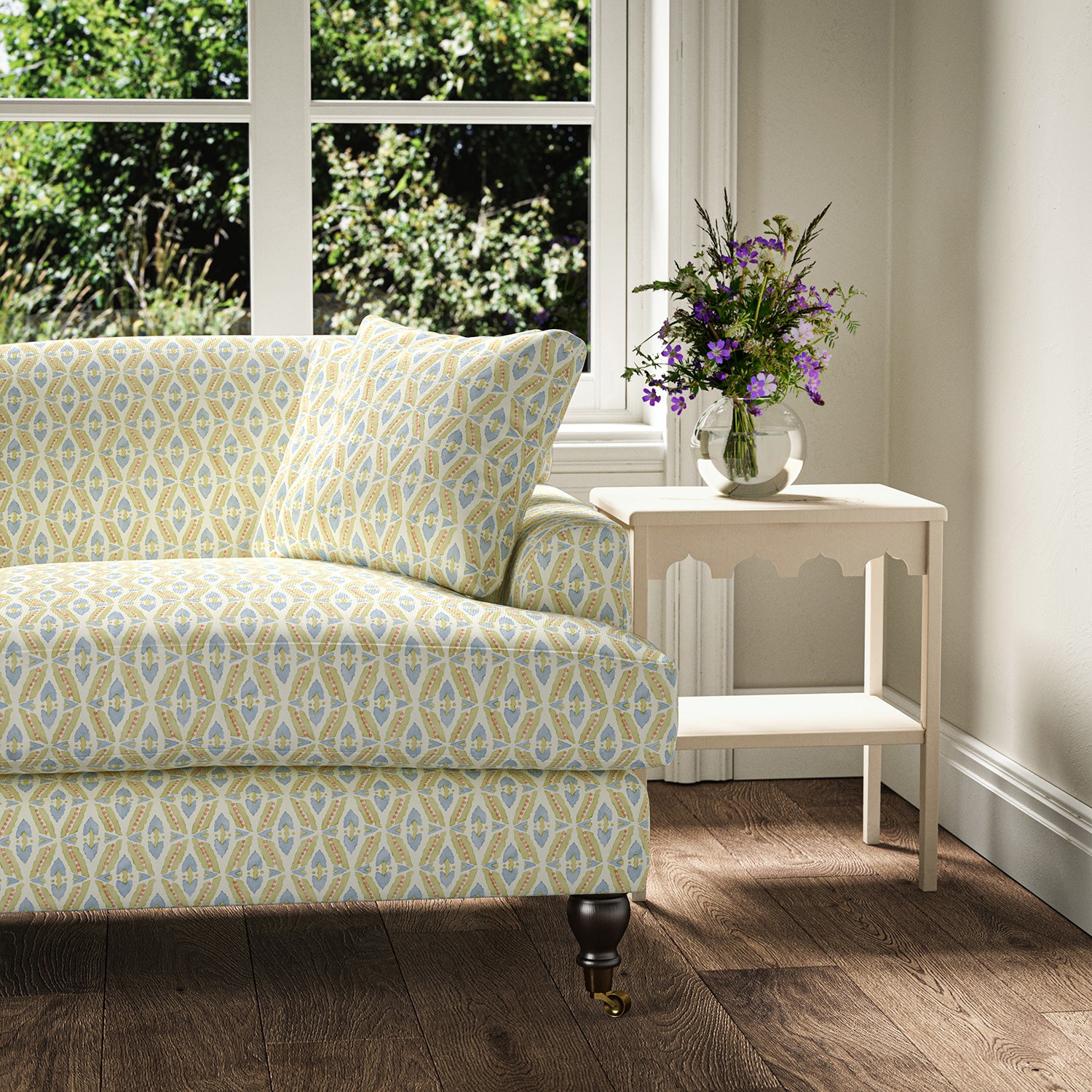 Printed linen fabric - a geometric design in pink, yellow and blue – on a sofa