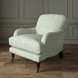 Printed linen fabric - a contemporary lattice design in blue, cream and white – on an armchair