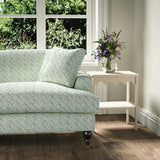 Printed linen fabric - a contemporary lattice design in blue, cream and white – on a sofa