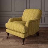 Printed linen fabric – a delicate pattern of moons and star-like dots in yellow and cream – on an armchair
