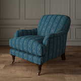 Printed linen fabric – a delicate pattern of moons and star-like dots in blue and cream – on an armchair