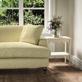 Printed linen fabric – damask-style pattern in yellow and cream – on a sofa