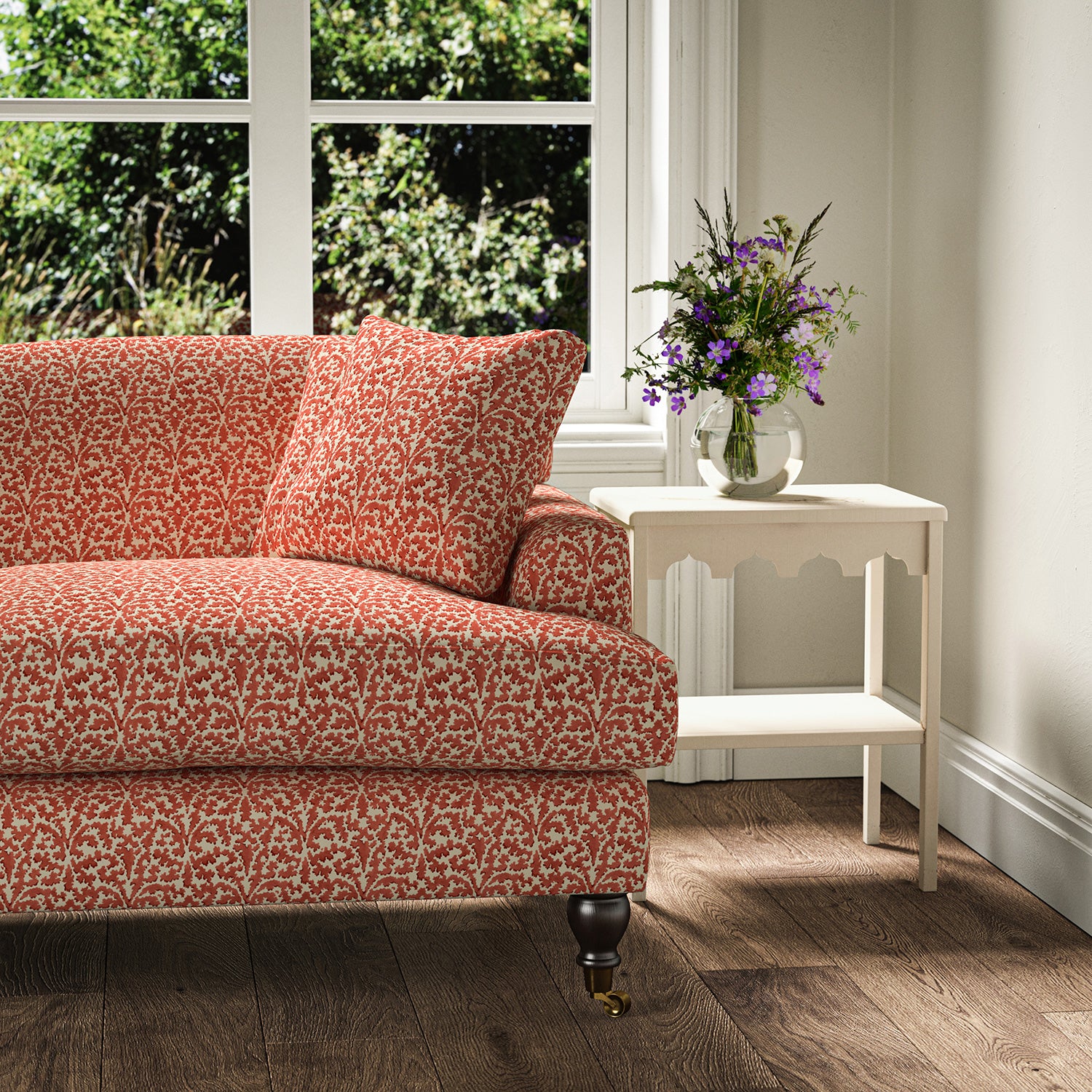 Printed linen fabric – damask-style pattern in red and cream – on a sofa