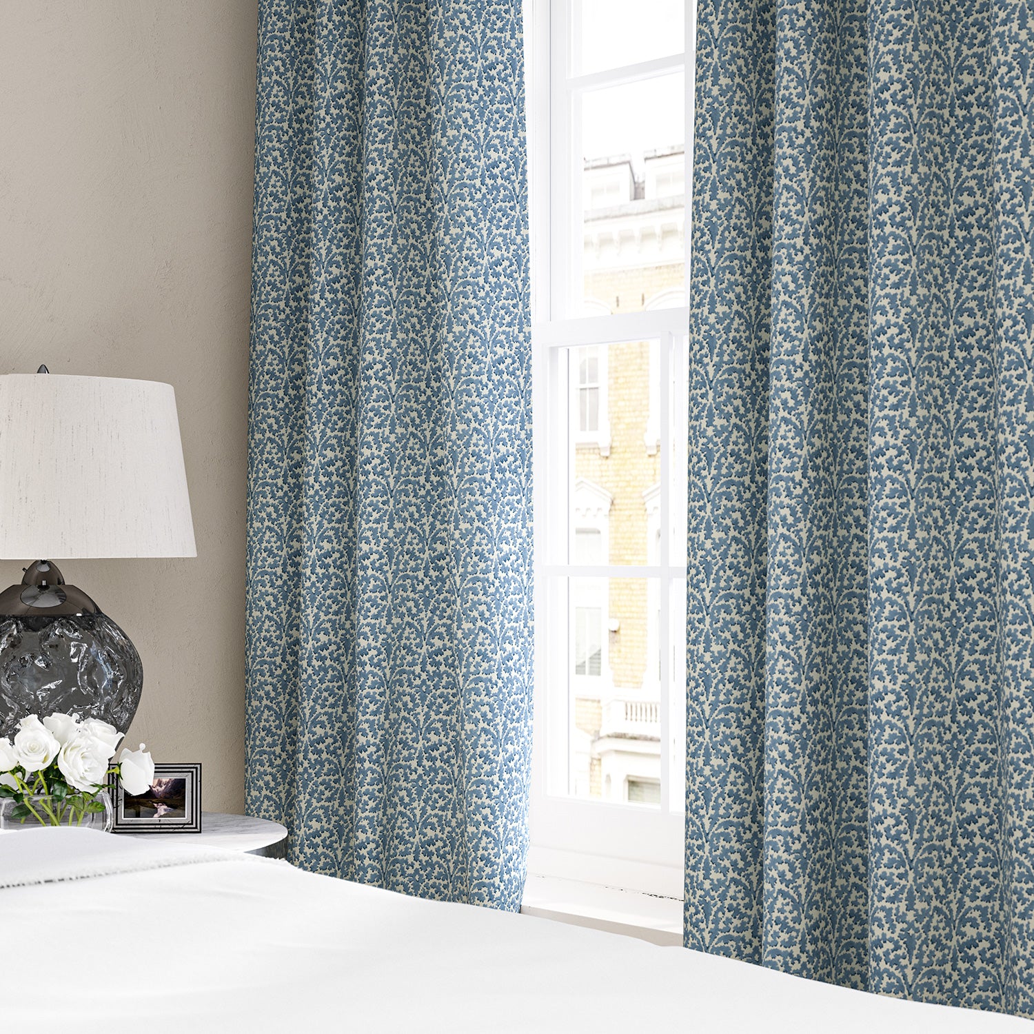 Linen curtains with a damask-style pattern in blue and cream