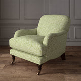 Printed linen fabric – damask-style pattern in green and cream – on an armchair