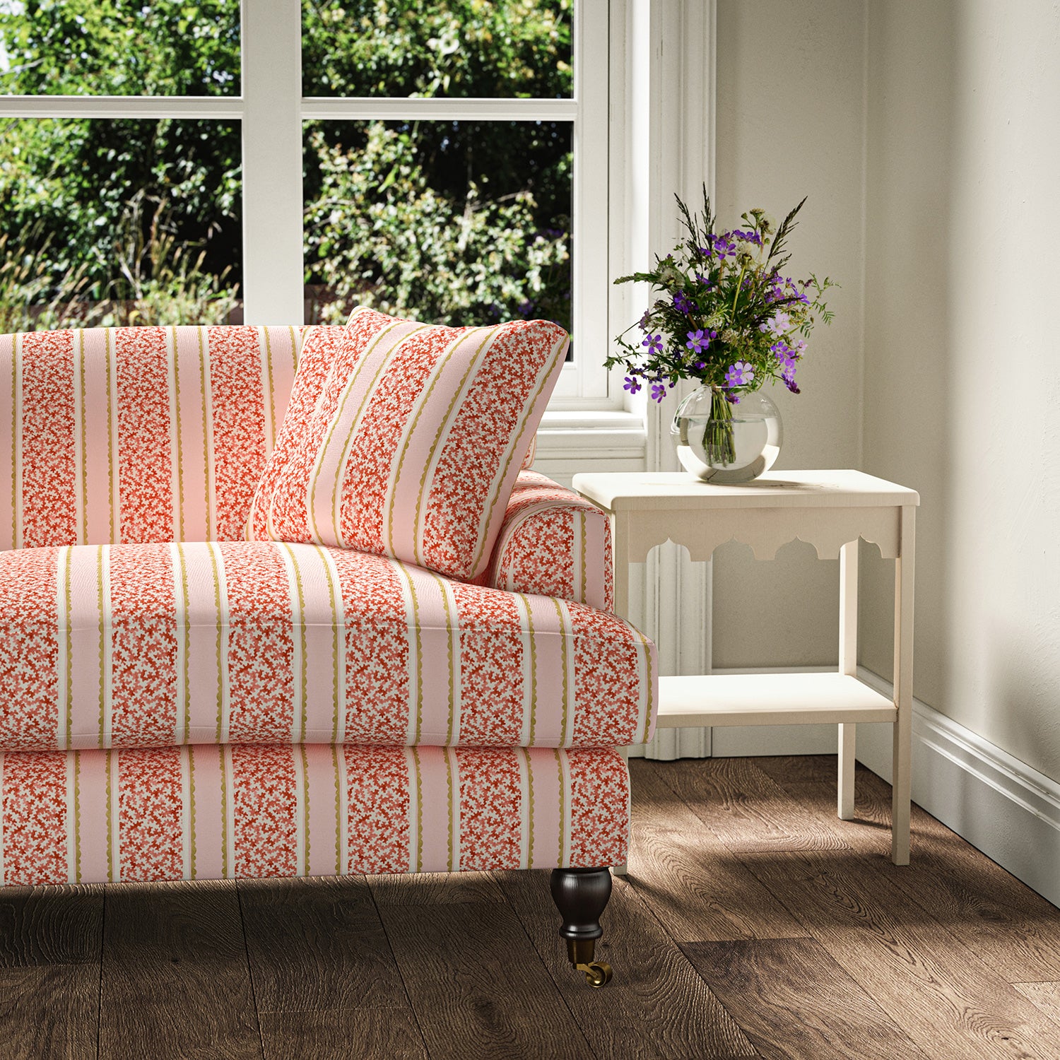 Printed linen fabric - fresh bands of jolly colours in pink, red, yellow and cream – on a sofa