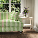 Printed linen fabric - fresh bands of jolly colours in green, pink and cream – on a sofa