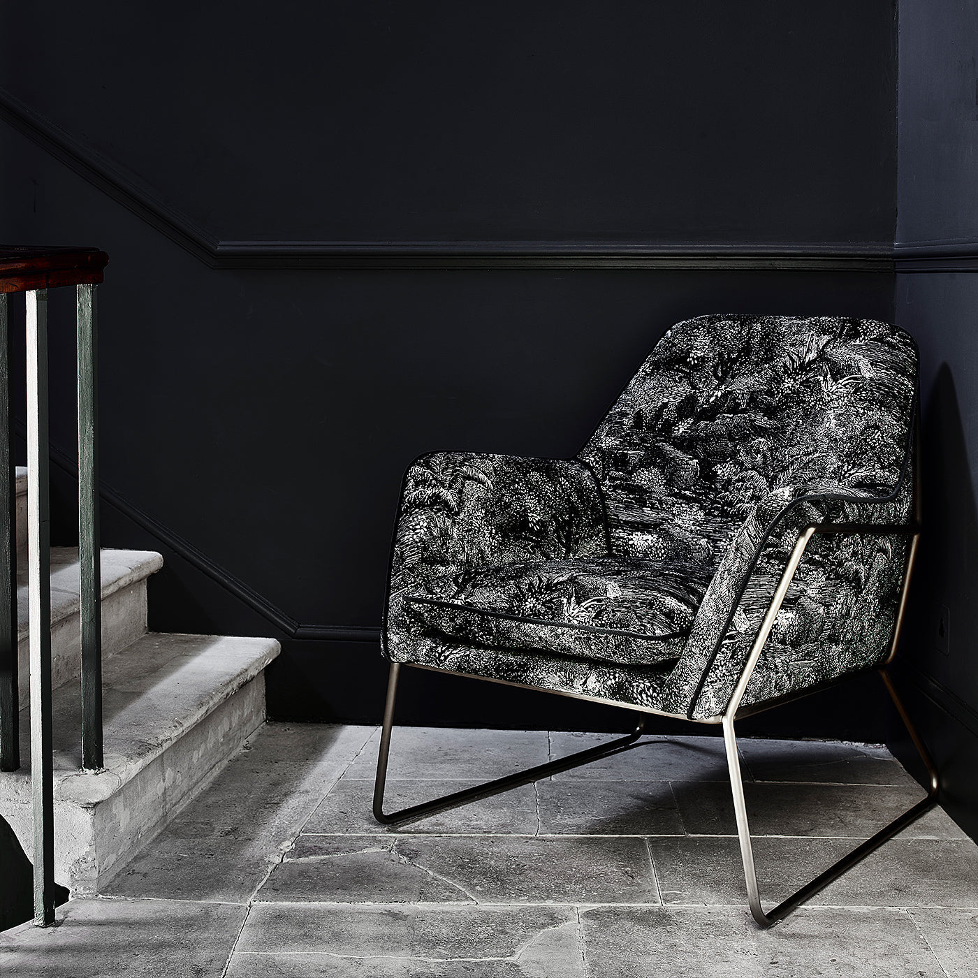 Luxurious printed velvet featuring a scenic/semi tropical design on a chair