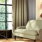 Living room featuring a sofa and curtains in a plain light green eco-friendly fabric