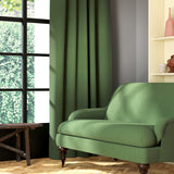 Living room featuring a sofa and curtains in a plain green eco-friendly fabric