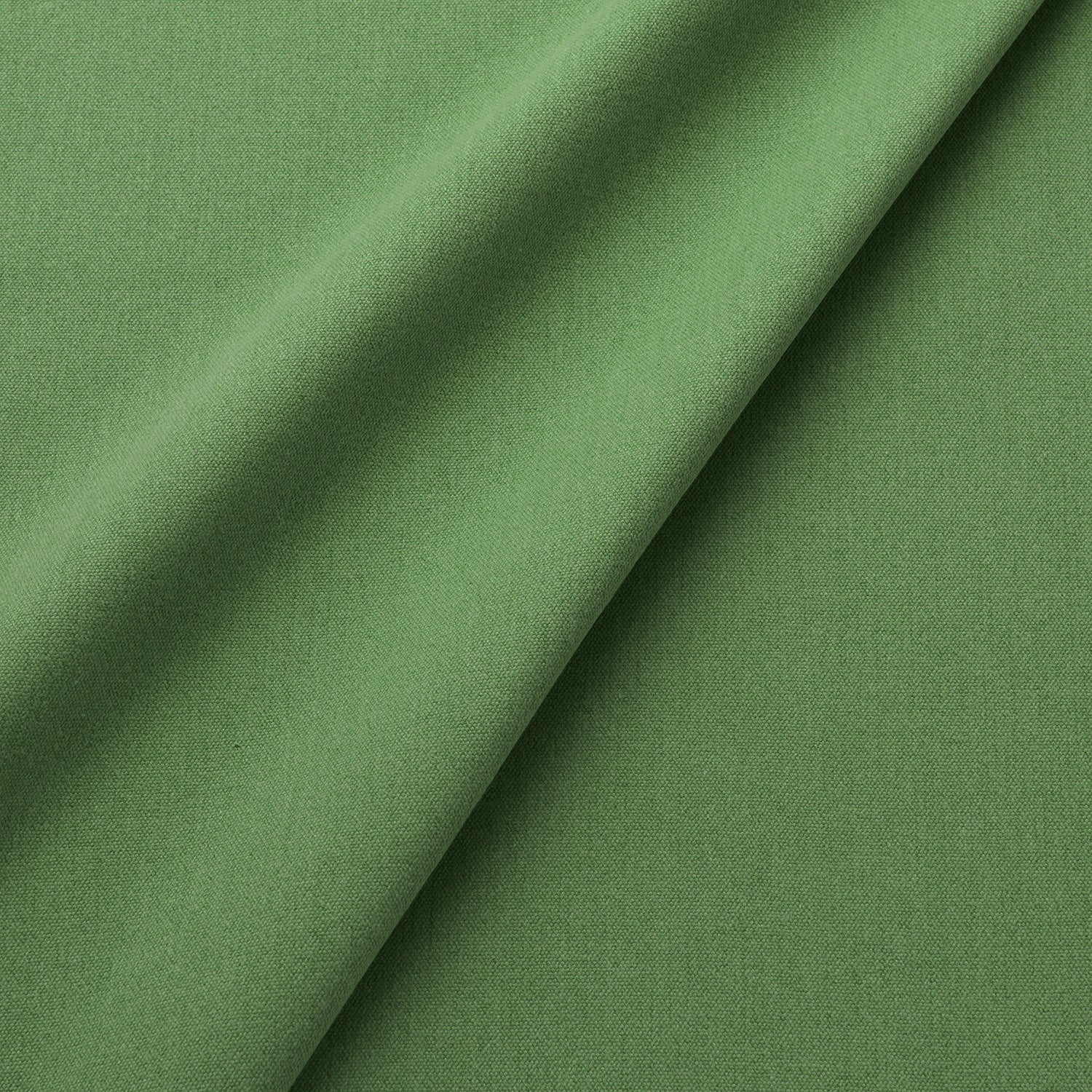 Fabric swatch of a eco-friendly plain green fabric for curtains and upholstery
