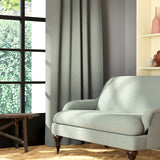 Living room featuring a sofa and curtains in a plain light blue eco-friendly fabric
