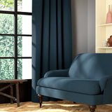 Living room featuring a sofa and curtains in a plain blue eco-friendly fabric