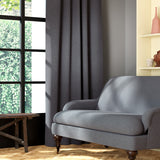 Living room featuring a sofa and curtains in a plain grey eco-friendly fabric