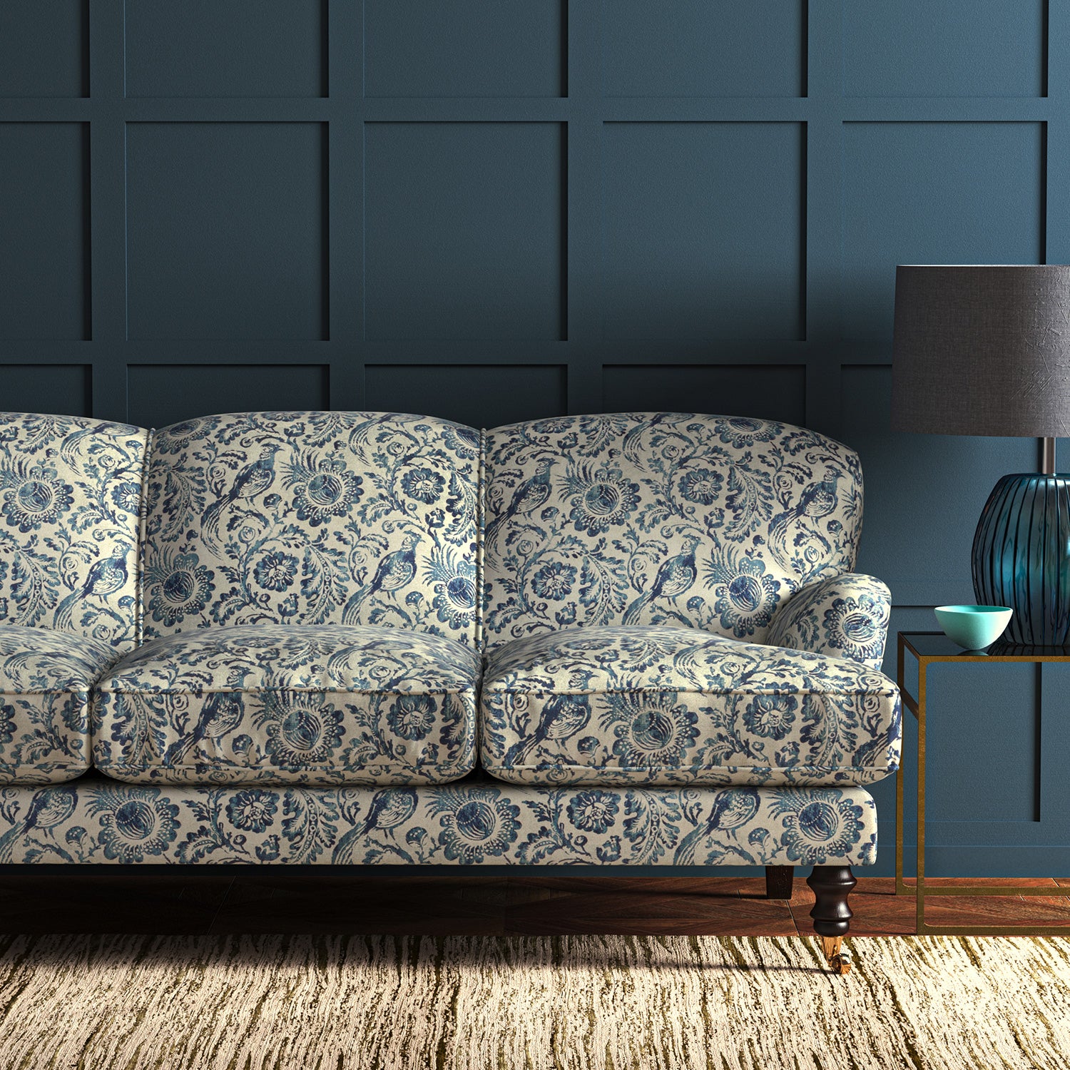 Sofa in velvet fabric with blue pheasant and floral design.