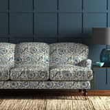 Sofa in velvet fabric with blue pheasant and floral design.