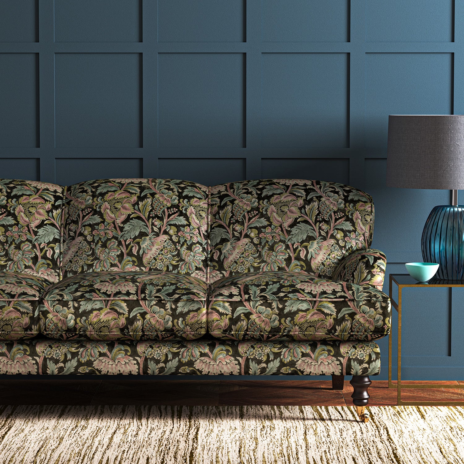 A printed velvet fabric showcasing an archival document, circa 1700s, this stylised floral is lavish, graceful, and timeless in brown, blue, pink and green on a sofa
