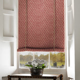 Blind in a red and neutral printed linen fabric with a geometric pattern