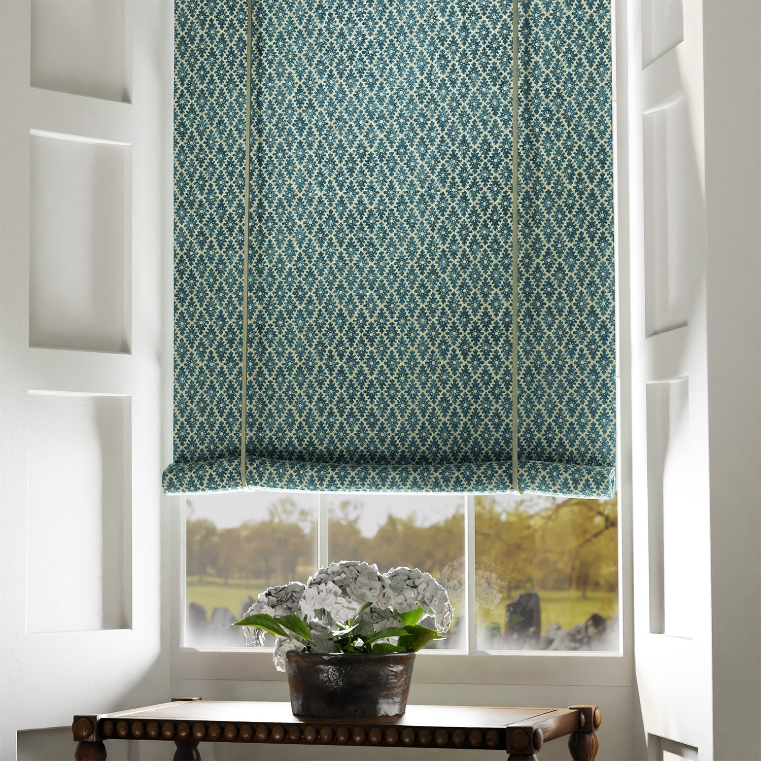Blind in a blue and neutral printed linen fabric with a geometric pattern