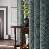 Curtains in a blue and neutral printed linen fabric with a geometric pattern