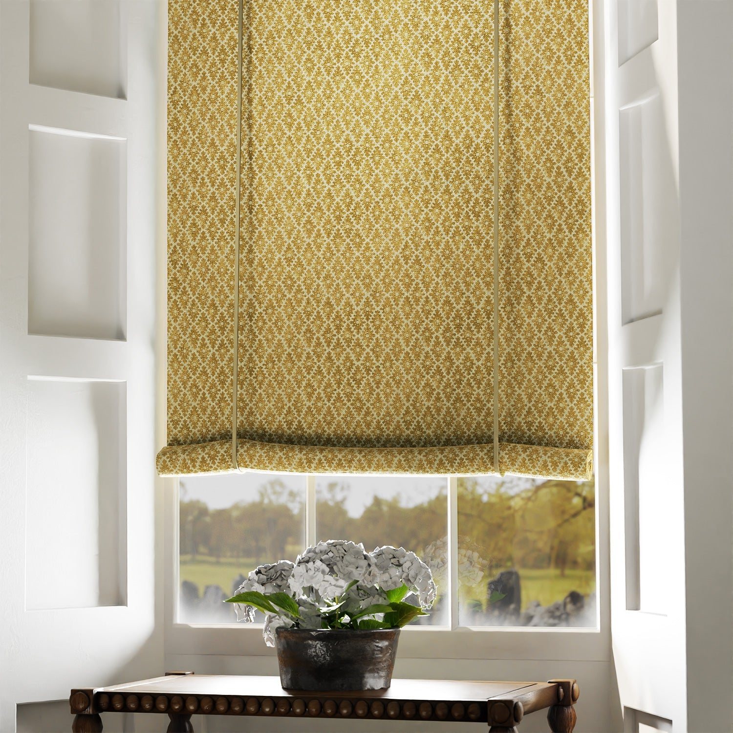 Blind in a yellow and neutral printed linen fabric with a geometric pattern