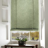 Blind in a green and neutral printed linen fabric with a geometric pattern