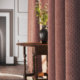 Curtains in a red and neutral printed linen fabric with a geometric pattern