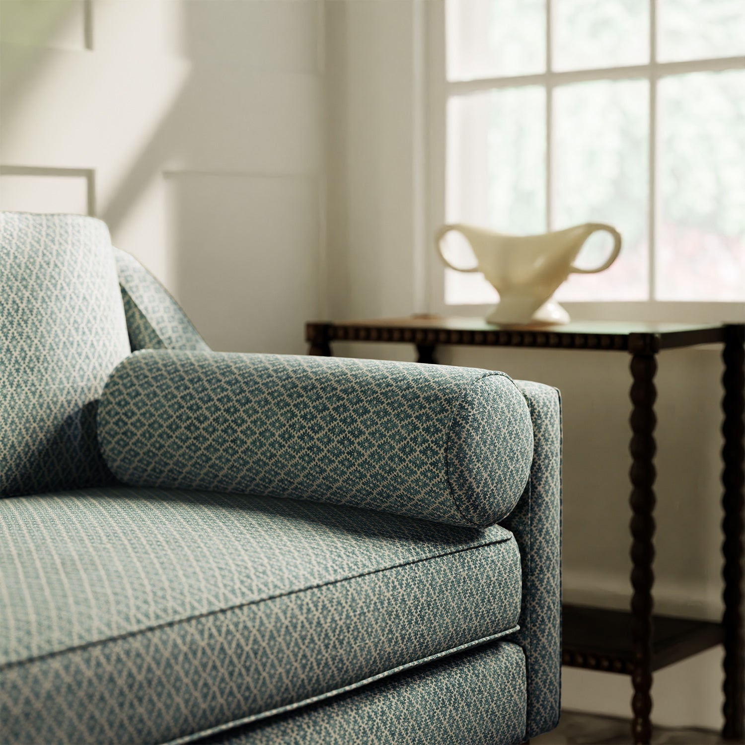 Sofa upholstered in a blue and neutral printed linen fabric with a geometric pattern