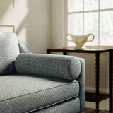 Sofa upholstered in blue and neutral printed linen fabric with a geometric pattern