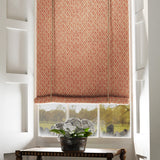 Blind in a orange and neutral printed linen fabric with a geometric pattern