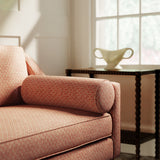 Sofa upholstered in a orange and neutral printed linen fabric with a geometric pattern
