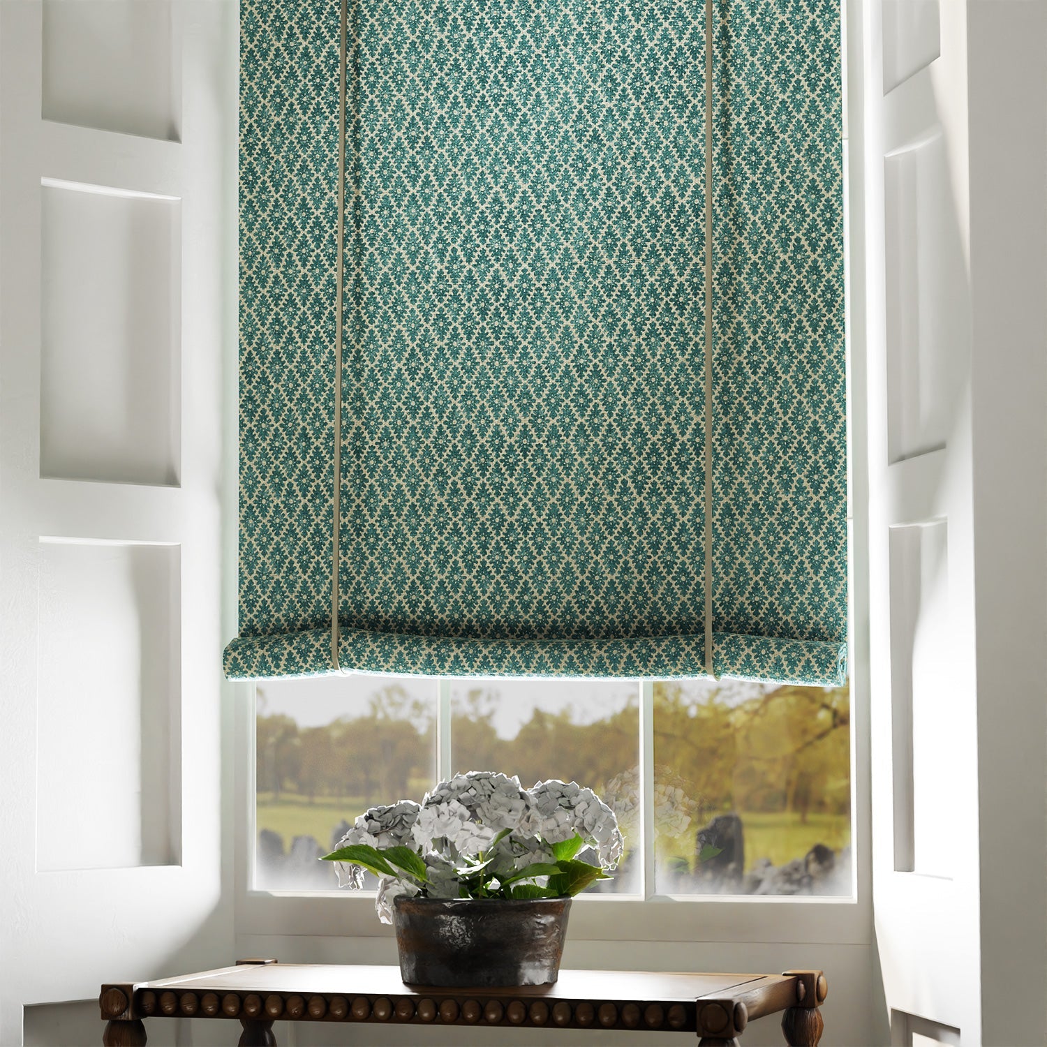 Blind in a blue and neutral printed linen fabric with a geometric pattern
