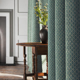 Curtains in a blue and neutral printed linen fabric with a geometric pattern