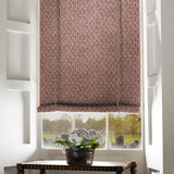Blind in a red and neutral printed linen fabric with a geometric pattern
