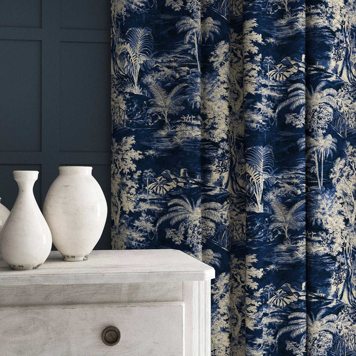 Curtain in a printed velvet fabric showcasing a rich, tropical-style toile in Indigo.