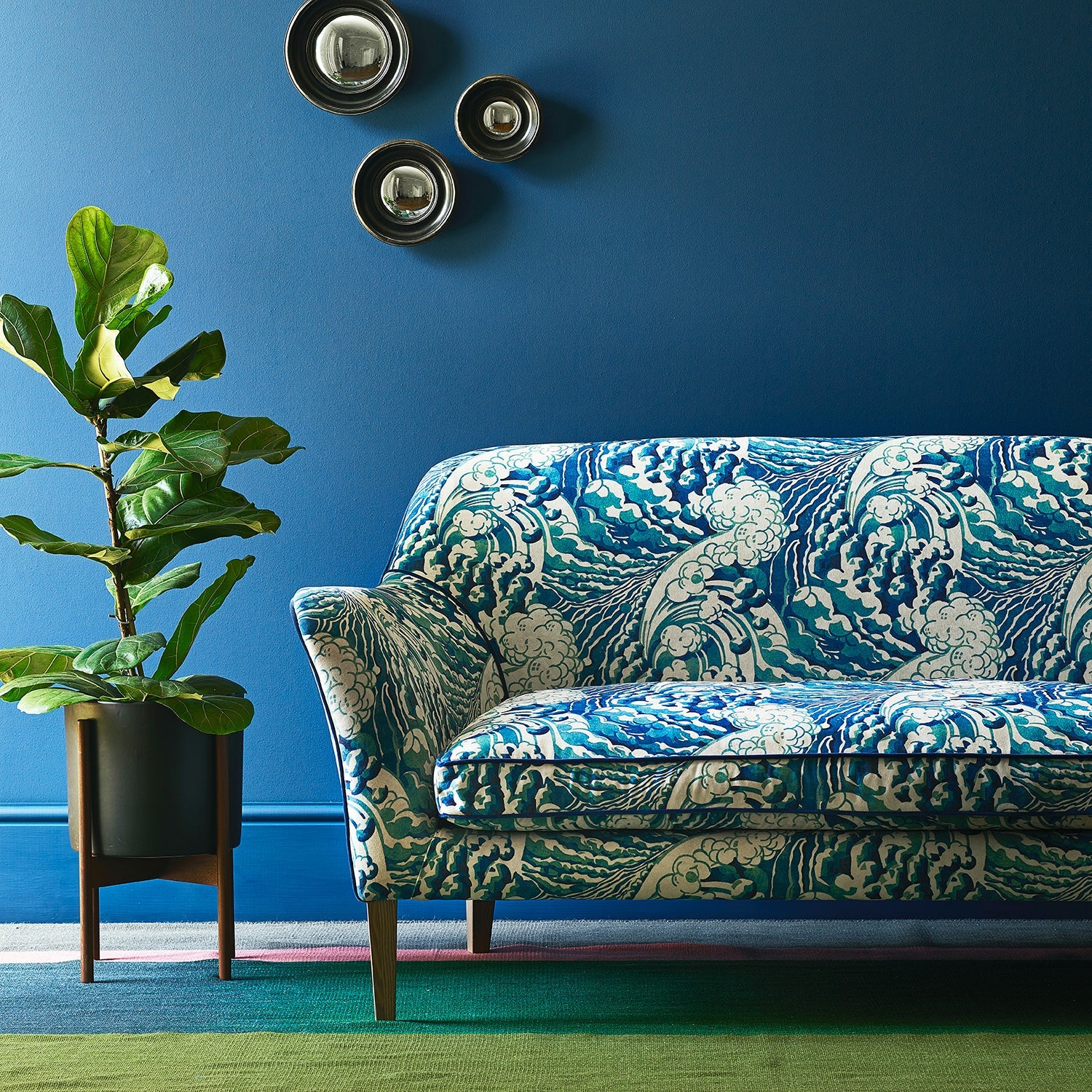 Velvet sofa upholstered in a blue and white velvet upholstery fabric with a wave design and stain resistant finish