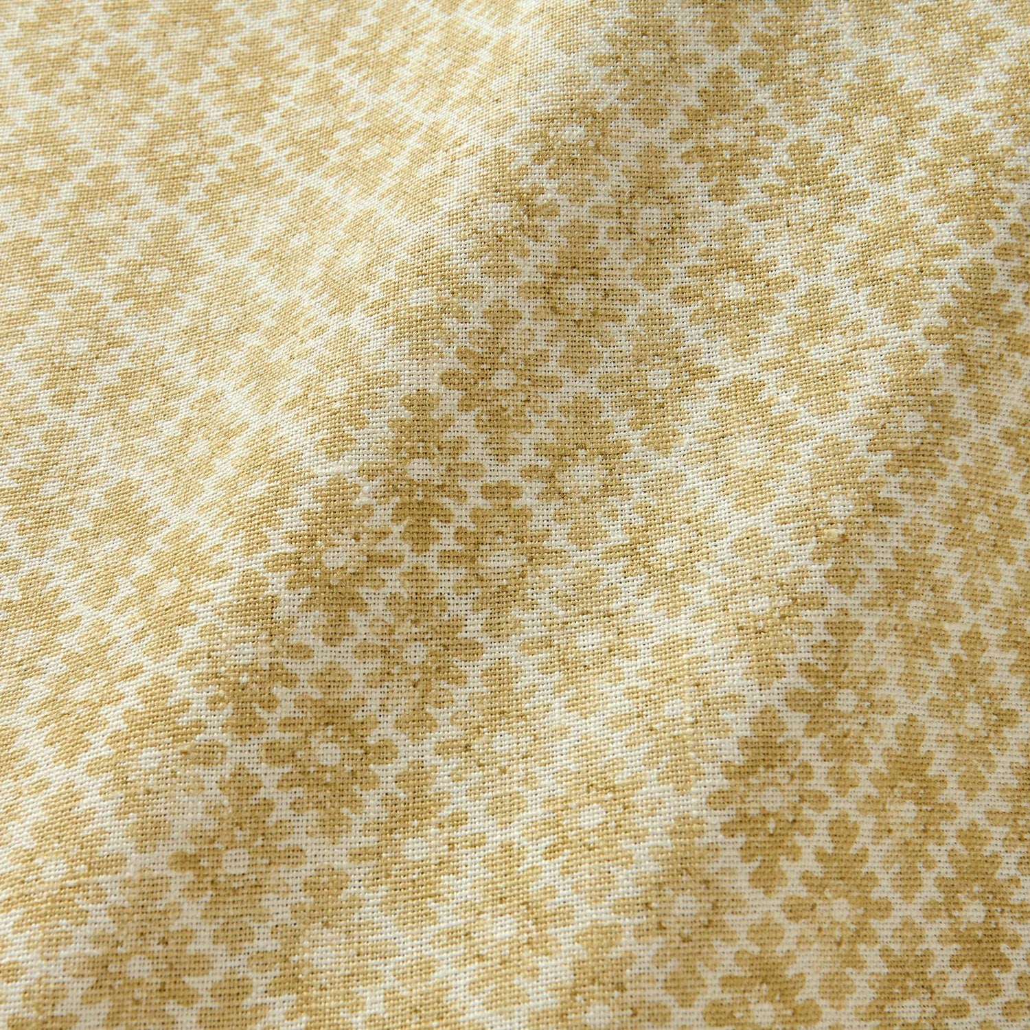 Fabric sample of a yellow and neutral printed linen fabric with a geometric pattern